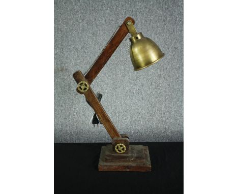 A wooden anglepoise type lamp with a metal shade and fixings. H.77cm. 