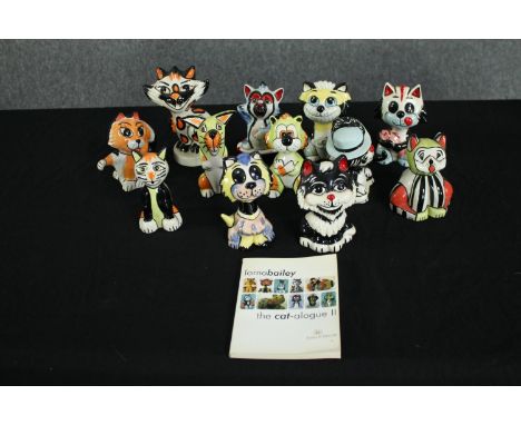 Twelve Lorna Bailey ceramic cats. Each hand painted and signed on the base. With a Lorna Bailey catalogue of cat figures. 16c