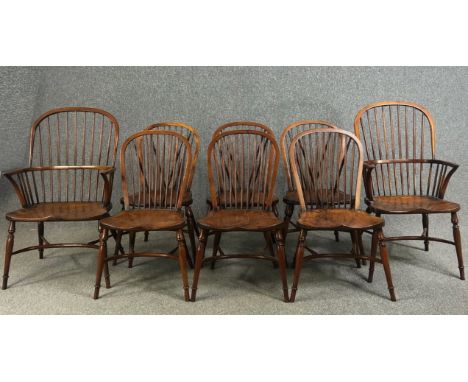 Dining chairs, a set of eight Windsor stick back style in yew with elm saddle seats on crinoline stretchered supports, stampe