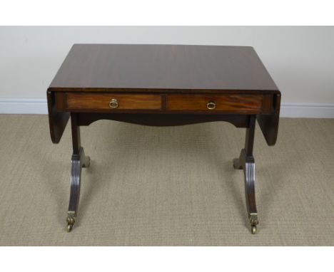 A Regency style mahogany Sofa Table by Waring and Gillow, Liverpool, fitted two drawers with ebonised stringing on reeded che