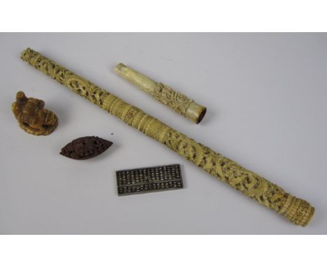 A Chinese carved ivory Parasol Handle, Cheroot Holder, a carved vegetable ivory Netsuke, a carved Nut formed as a boat and a 