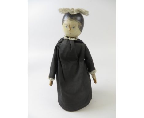 A South German carved wooden Doll assembled as a pin cushion. Emery filled, circa 1880, H 10 1/4