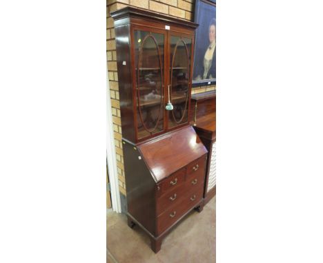 An Edwardian mahogany Bureau Bookcase with pair of glazed doors above fall with chevron stringing, three drawers beneath on b