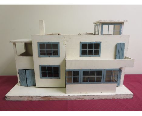 A cream and blue painted Triang Ultra Modern Doll's House, model No 3139. Metal window frames. Front opening. Four rooms with