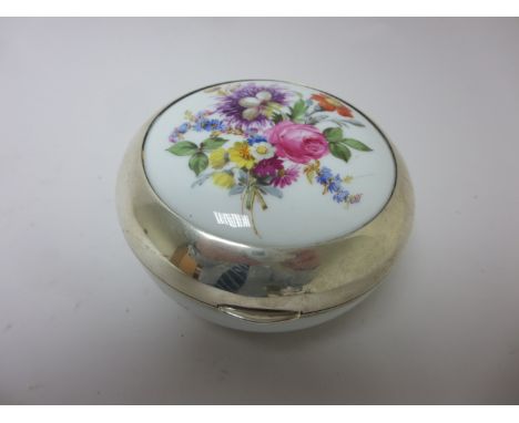 A silver mounted and lidded Meissen circular Box painted floral bouquets in bright enamels, 4 3/4in, blue crossed swords mark