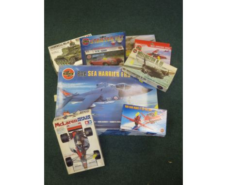 Two boxes of Airfix and Tamiya plastic Kits including 1:48 scale Spitfire and Hurricane, 1:24 scale BAE Harrier, tanks, cars 