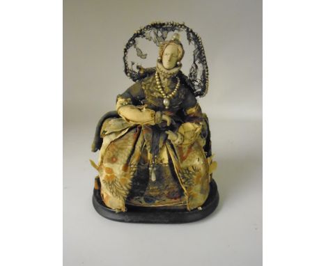 A ceramic headed Figure representing Elizabeth I costumed in 18th Century silks and other fabrics. Under a glass dome. The ru