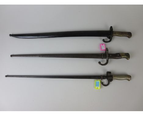 A French 1886 Model Epe Bayonet in scabbard, an 1866 Model Sabre Bayonet in scabbard and an 1874 Model Epe Bayonet in scabbar