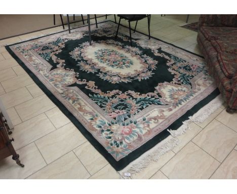 A Chinese green ground Carpet with central floral design lozenge, 11ft x 8ft approx