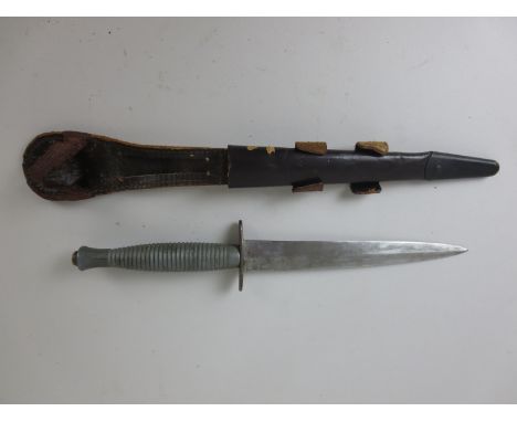 A British Commando type Dagger in leather belt scabbard