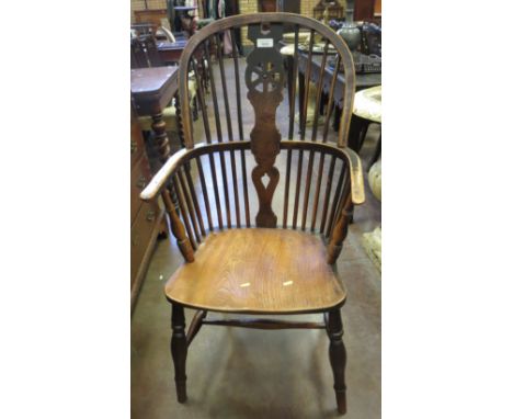 A 19th Century Windsor Elbow Chair with pierced splat and stick back, solid seat on turned supports