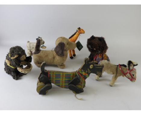A 1940's Chad Valley pull along Scottie Dog, Steiff donkey, fur faced cat, Lincoln battery dog, drum playing monkey, etc (7)