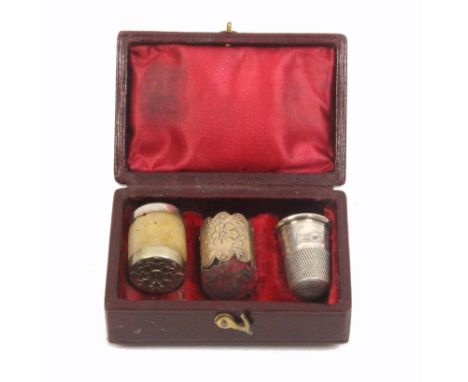 A silver sewing trio in rectangular case, the case in red leather with circular colour print of a girl to lid, the interior w