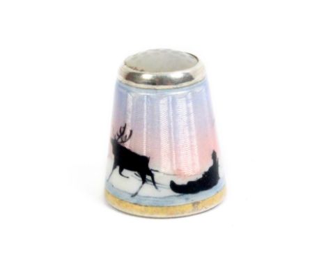 A Norwegian enamel thimble by Clement Berg, stone top the sides in black silhouette with a reindeer pulling a Sami in a sled 