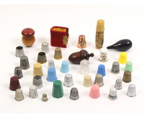 Thimbles and thimble cases comprising a velour book form thimble case with thimble 'Silver Cased Thimble Rd. 169666', 4cm, th