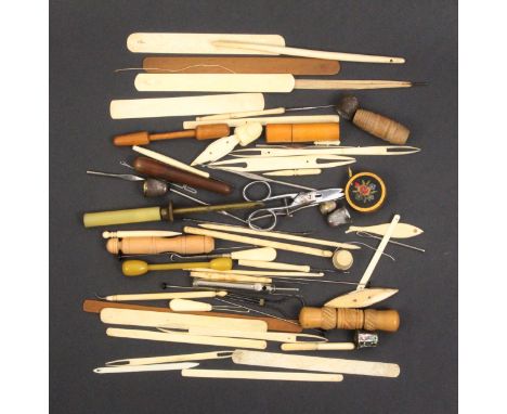 A mixed lot - sewing - comprising netting tools, crochet hooks, two bone shuttles, four needle cases, thimbles and other piec