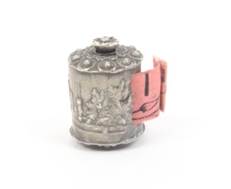 A scarce silver pictorial tape measure of cylinder form depicting the gate house of Kenilworth Castle, amid trees, flowerhead