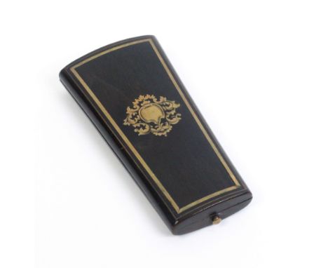 A French ebonised and brass inlaid etui, circa 1860, of oval section and tapering form, the lid with brass inlaid cartouche w