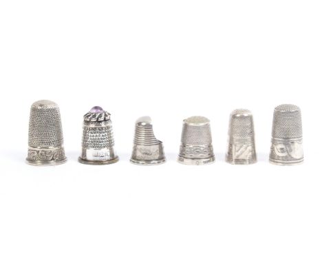 Six English silver thimbles including three tall 19th Century examples with decorative borders, a thimble guard, a stone top,