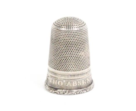 An early 19th Century silver thimble, the frieze inscribed 'The Absent Ever Dear', on a ribbed ground over foliate rim