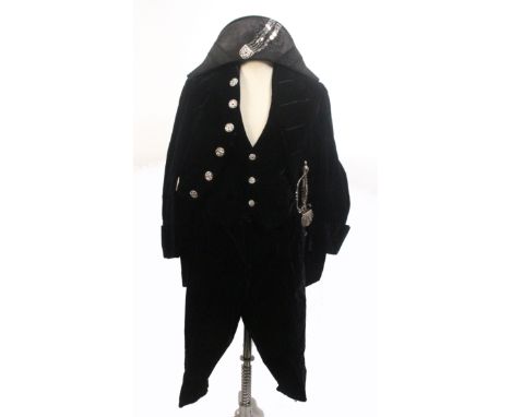 A Victorian court suit comprising black velvet tail coat, waistcoat and breeches all with cut steel buttons, bicorn hat with 