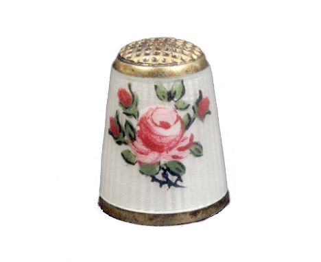 A 20th Century silver gilt and enamel thimble, the ribbed ivory enamel ground decorated with roses