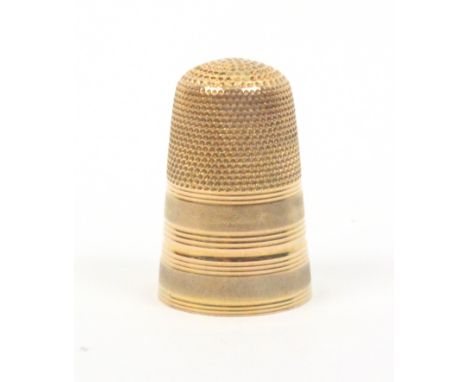 A gold thimble with two frosted bands divided by ring turned bands