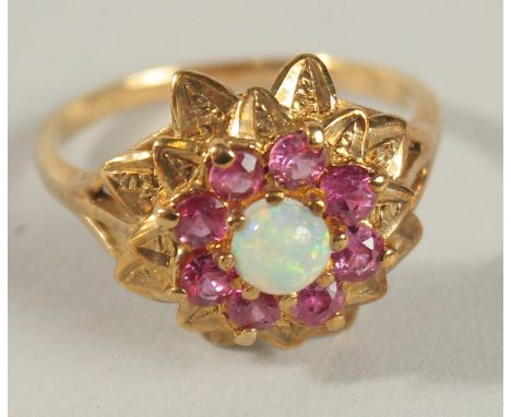 A RUBY AND OPAL GOLD RING.