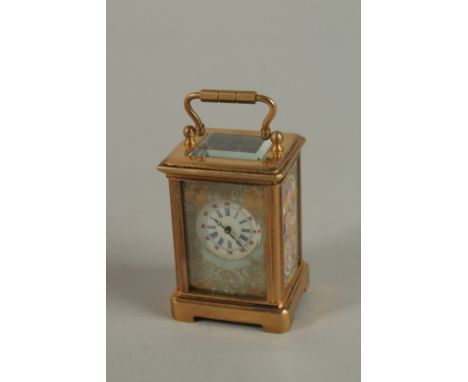 A MINIATURE BRASS CARRIAGE CLOCK with painted panels and carrying handle. 6cm high.