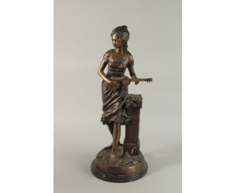 A GOOD BRONZE OF A YOUNG GIRL playing guitar, on a circular base. 66cm high.