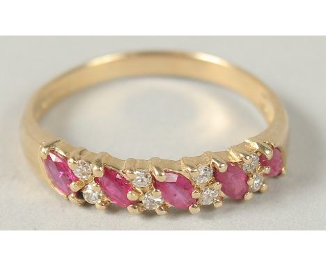 A 9CT YELLOW GOLD 9 STONE MARQUISE RUBY AND R/C DIAMOND RING, boxed.