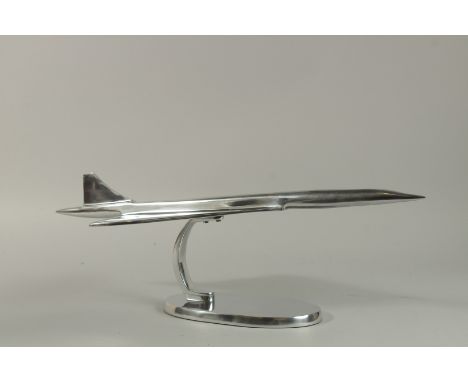 A LARGE CHROME MODEL OF CONCORDE on an oval base. 60cm long.