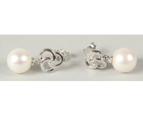 A PAIR OF 9CT  WHITE GOLD ROUND FRESHWATER PEARL AND DIAMOND PIN WHEEL EARRINGS. Diamonds 0.05ct.