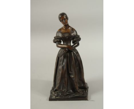 A GOOD 19TH CENTURY BRONZE OF A YOUNG LADY, hands crossed holding a book. 30cms high.