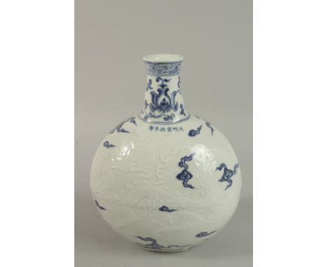 A CHINESE BLUE AND WHTIE PORCELAIN CARVED DRAGON MOON FLASK. 30cm high.