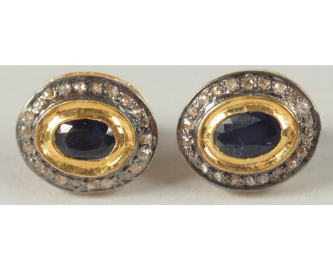 A PAIR OF OVAL SAPPHIRE AND R/C DIAMOND HALO STUD EARRINGS, set in gold plated silver, boxed. Sapphires, 0.45ct approx..  Dia