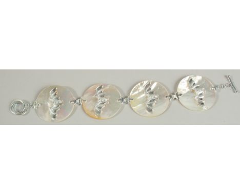 A SILVER AND MOTHER OF PEARL BAT BROOCH.
