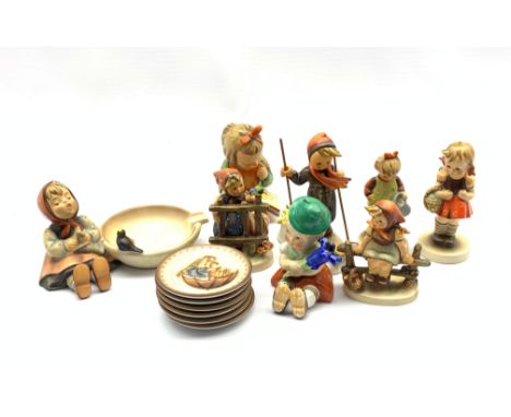 Group of Goebel figures comprising Skier Boy no. 59, Book Worm, School Girl no. 81, Happy Pastime ashtray no. 62 together wit