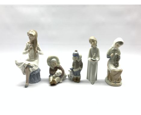 Two Lladro figures of Eskimo children with polar bear cubs, Nao figure of a girl brushing her hair and two other figures - Co