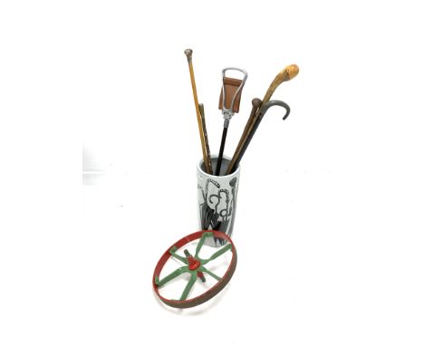 Modern umbrella stand, decorated in black and white with umbrellas, silver topped cane, shooting stick, other walking sticks 