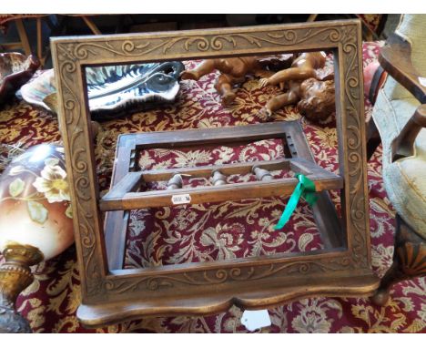 A 19thC French walnut folding bible stand the framed carved with foliate scrolls over a serpentine shelf and raised on squat 