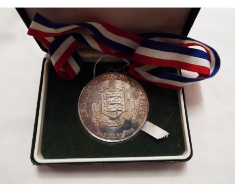 A silver plated Amateur Boxing Association Senior Championships Finals medal for light flyweight division, cased with ribbon