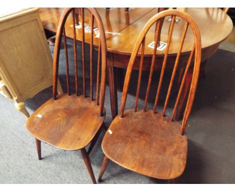 A set of four Ercol dark elm hoop-back chairs