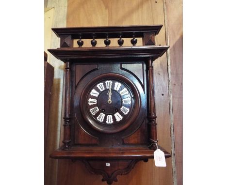 A French mahogany wall clock, the galleried top over a circular dial with enamel Roman numerals and flanked by fluted column 