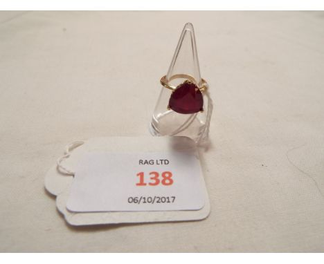 A 9ct gold ring inset with large triangular ruby, size J     1.1cm diameter surface wear but no chips or cracks