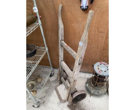 A VINTAGE WOODEN SACK TRUCK WITH CAST IRON WHEELS 