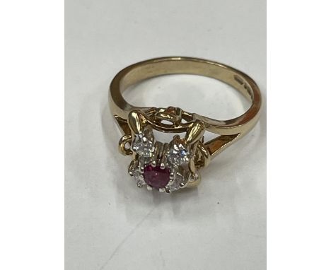 A 9 CARAT GOLD RING WITH CENTRE RUBY SURROUNDED BY CUBIC ZIRCONIAS SIZE K 