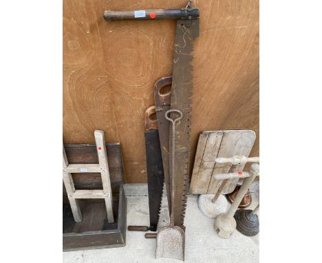 THREE VINTAGE CROSS CUT SAWS AND A VINTAGE CAST IRON DOUGH SHOVEL 