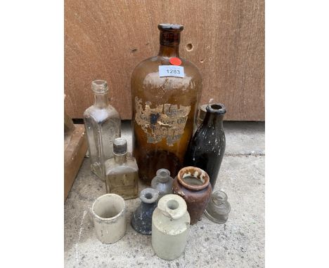 AN ASSORTMENT OF VINTAGE GLASS AND STONEWARE BOTTLES 