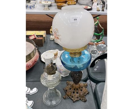 TWO VINTAGE OIL LAMPS, ONE WITH AN ORNATE BRASS BASE, BLUE GLASS MIDDLE AND FLORAL SHADE, HEIGHT  52CM PLUS A CLEAR GLASS OIL